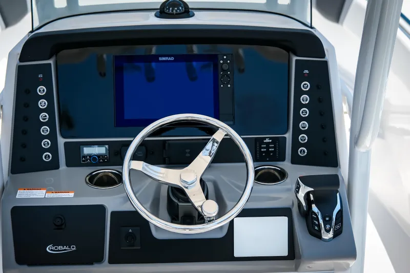 Slide: The Image of 2025 Robalo R230 Center Console dashboard with steering wheel and navigation controls. - 7
