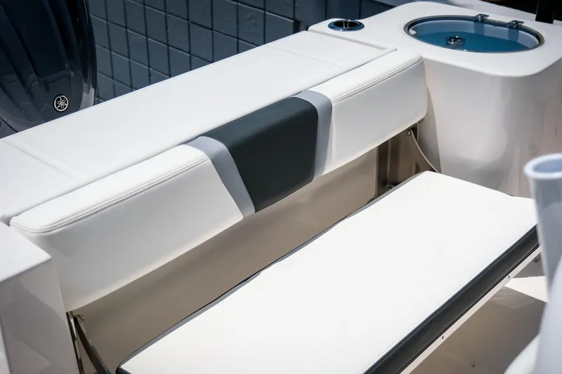 Slide: The Image of 2025 Robalo R230 Center Console boat seating and livewell detail. - 8