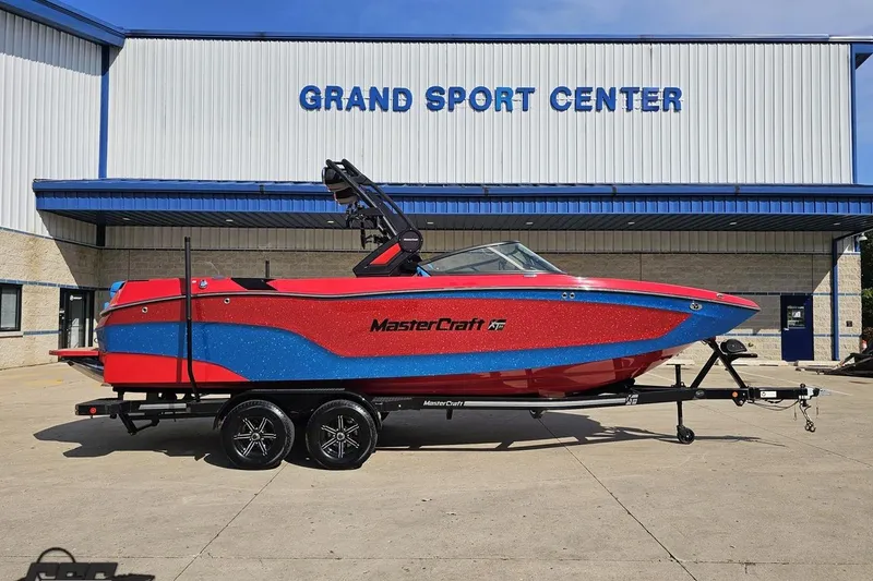 The Image of 2022 MasterCraft XT24 boat in red and blue at Grand Sport Center. - 1