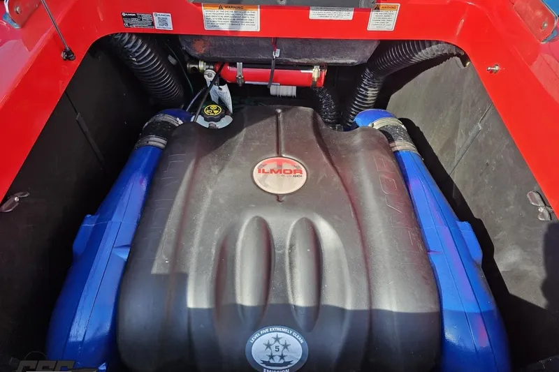 Slide: The Image of Engine compartment of a 2022 MasterCraft XT24 boat featuring Ilmor engine components. - 100