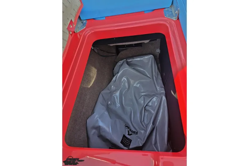Slide: The Image of Storage compartment of 2022 MasterCraft XT24 boat with gray cover inside. - 101