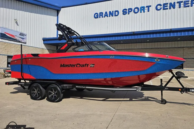 Slide: The Image of 2022 MasterCraft XT24 boat in red and blue at Grand Sport Center. - 13