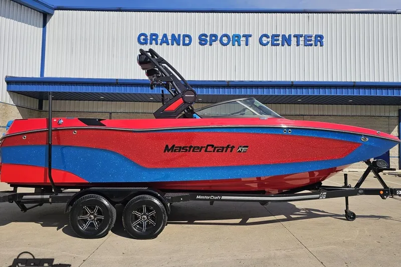 Slide: The Image of 2022 MasterCraft XT24 boat in red and blue at Grand Sport Center. - 3