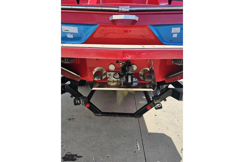 Slide: The Image of Rear view of a 2022 MasterCraft XT24 boat, showcasing its red exterior and hardware. - 31