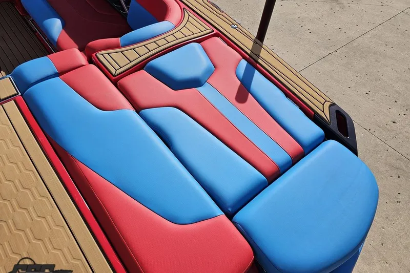 Slide: The Image of 2022 MasterCraft XT24 boat interior with red and blue cushioned seating. - 39