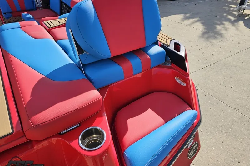 Slide: The Image of Red and blue seating on 2022 MasterCraft XT24 boat, featuring cup holders and stylish design. - 40