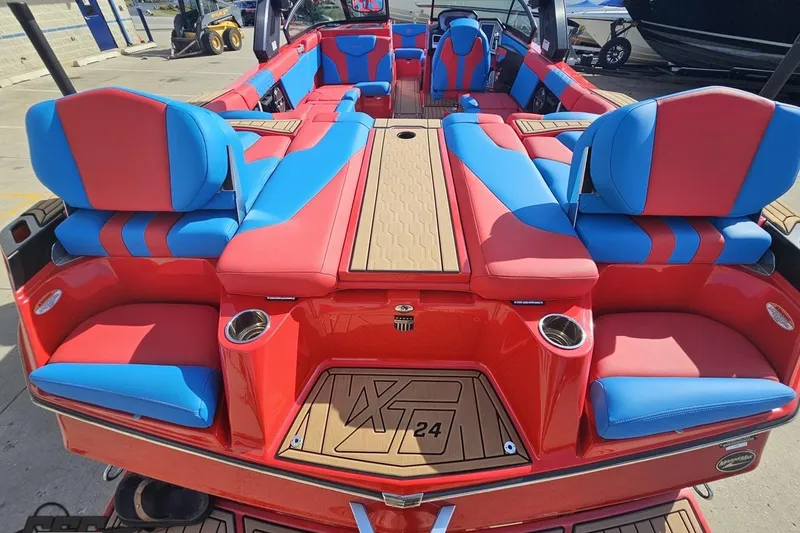 Slide: The Image of 2022 MasterCraft XT24 boat with vibrant red and blue seating, docked outdoors. - 41