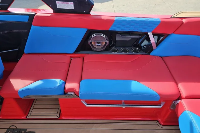Slide: The Image of Red and blue seating in 2022 MasterCraft XT24 boat interior. - 56