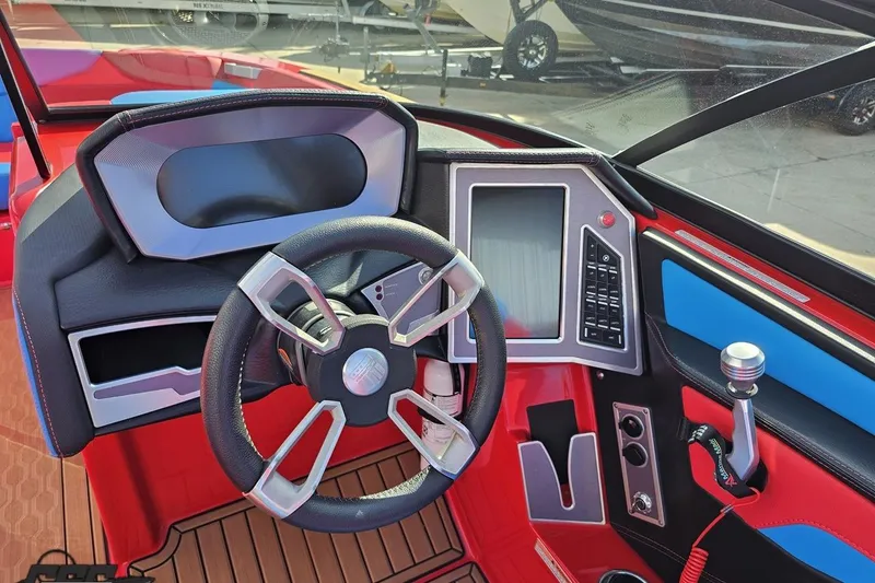 Slide: The Image of 2022 MasterCraft XT24 boat dashboard with steering wheel and control panel. - 64