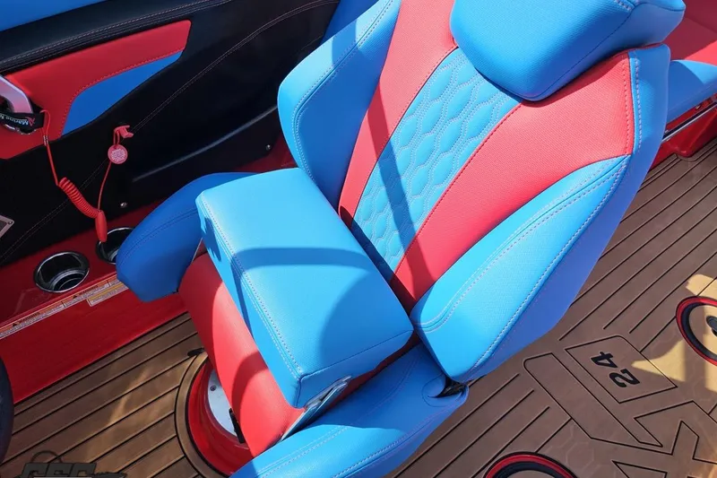 Slide: The Image of 2022 MasterCraft XT24 boat seat with vibrant blue and red upholstery. - 66