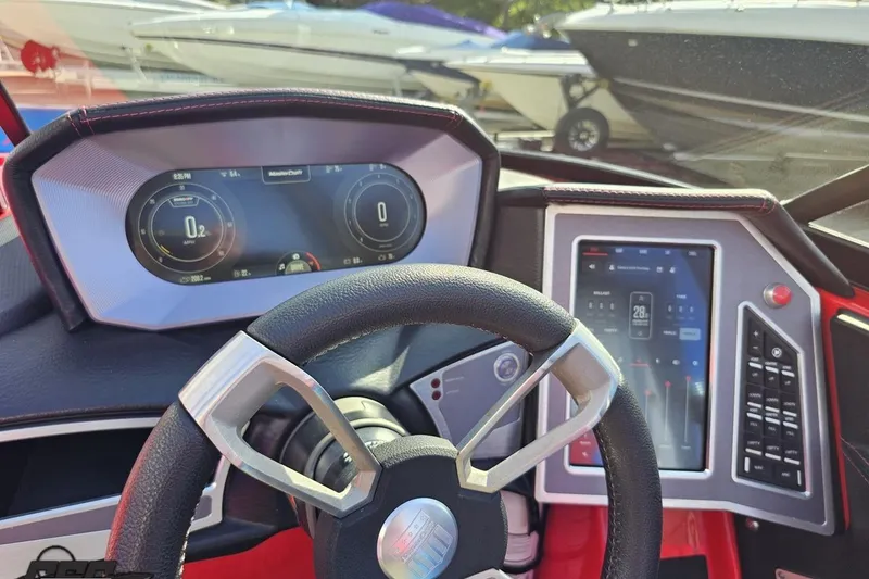 Slide: The Image of Steering wheel and dashboard of 2022 MasterCraft XT24 boat with digital displays. - 69