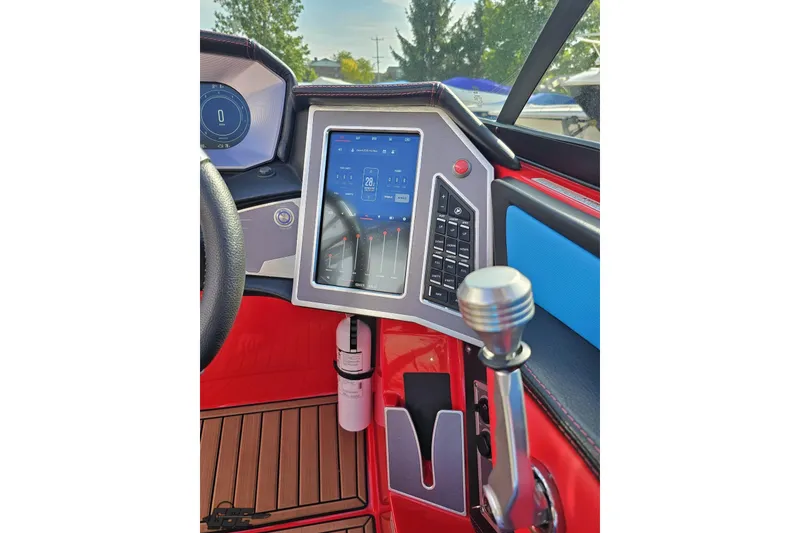 Slide: The Image of 2022 MasterCraft XT24 boat dashboard with touchscreen controls and modern steering. - 70