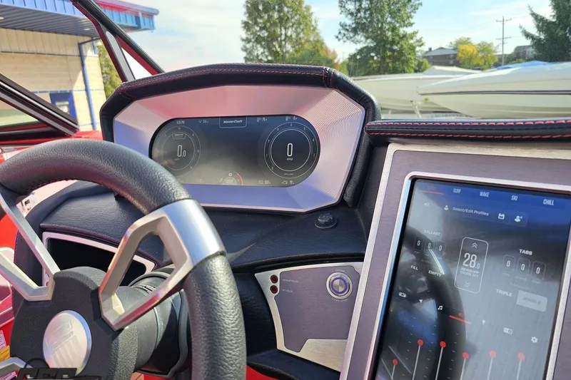 Slide: The Image of 2022 MasterCraft XT24 dashboard with digital displays and steering wheel. - 72
