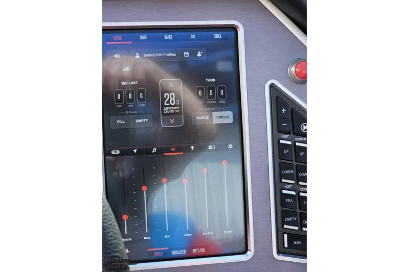 Slide: The Image of 2022 MasterCraft XT24 touchscreen control panel displaying ballast and audio settings. - 73