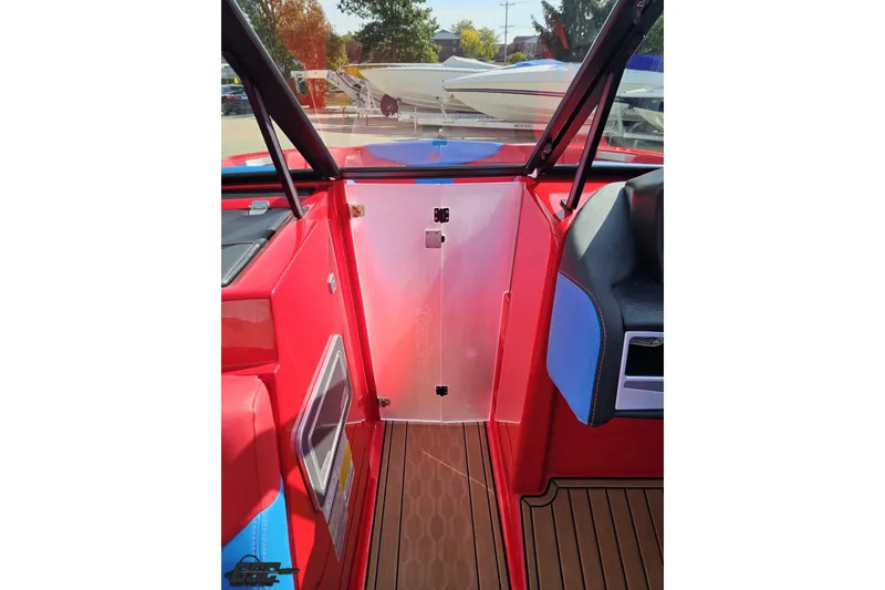 Slide: The Image of 2022 MasterCraft XT24 boat interior with red and blue accents, featuring a sleek design. - 77