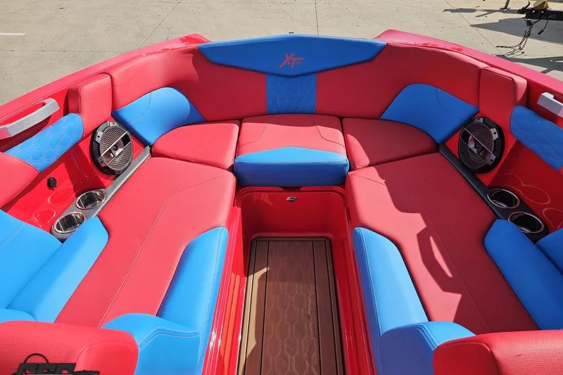Slide: The Image of Red and blue interior of 2022 MasterCraft XT24 boat with speakers and cup holders. - 79