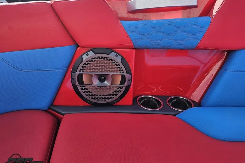 Slide: The Image of Red and blue interior of 2022 MasterCraft XT24 with speaker and cup holders. - 84