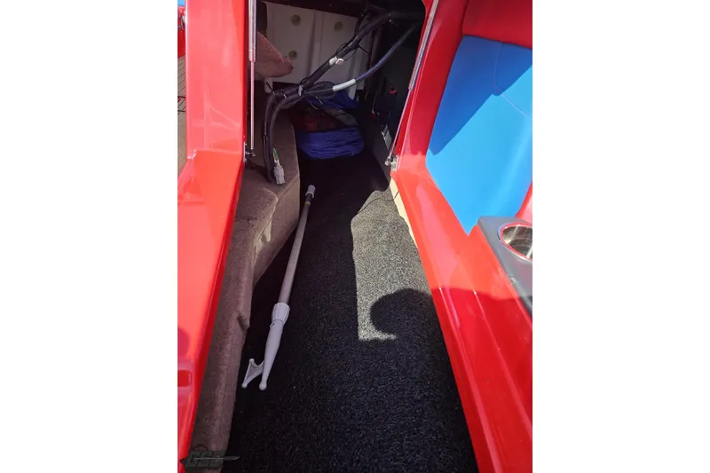 Slide: The Image of Interior view of 2022 MasterCraft XT24 boat storage compartment with red and blue accents. - 89