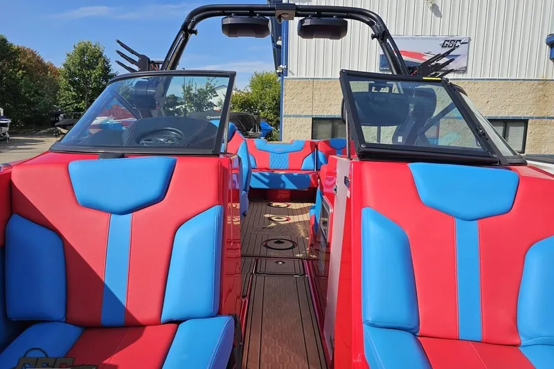 Slide: The Image of 2022 MasterCraft XT24 boat interior with vibrant red and blue seating. - 90