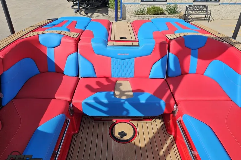 Slide: The Image of 2022 MasterCraft XT24 boat interior with vibrant red and blue seating. - 95