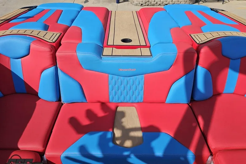 Slide: The Image of 2022 MasterCraft XT24 boat interior with vibrant red and blue seating design. - 96