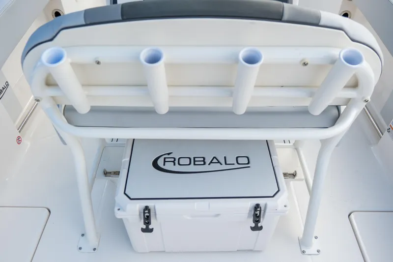 Slide: The Image of 2025 Robalo R250 Center Console boat with rod holders and branded cooler. - 11