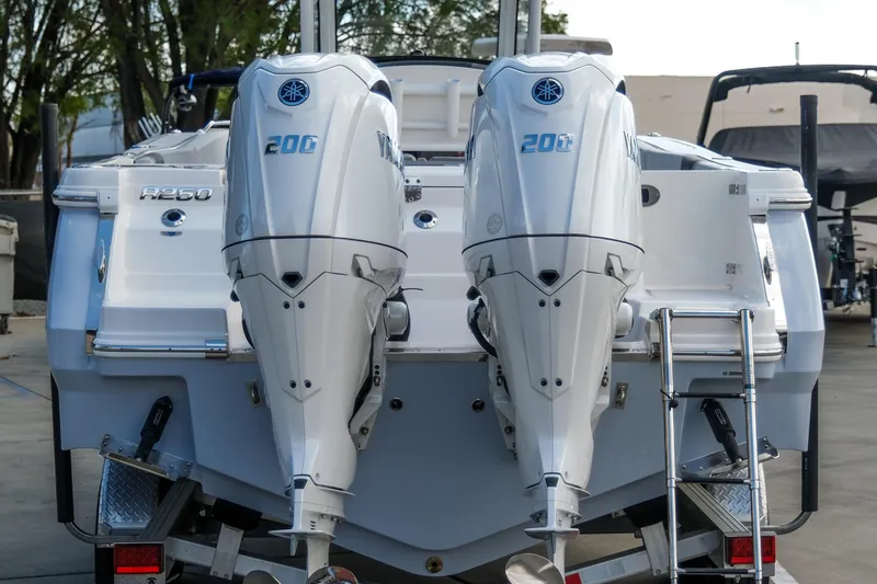 Slide: The Image of 2025 Robalo R250 Center Console with twin Yamaha 200 engines, rear view. - 4