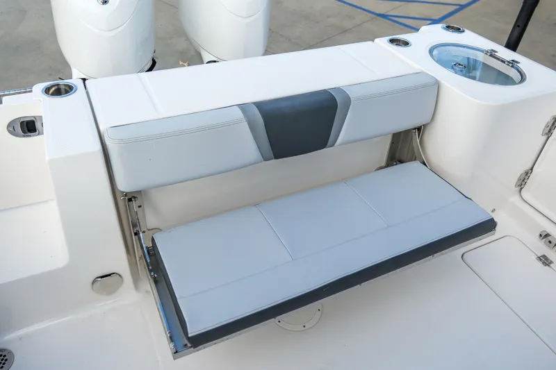 Slide: The Image of 2025 Robalo R250 Center Console boat with foldable seating and cup holders. - 9