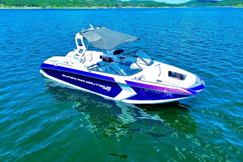 Slide: The Image of 2017 Nautique Super Air Nautique G23 boat on a serene lake. - 11