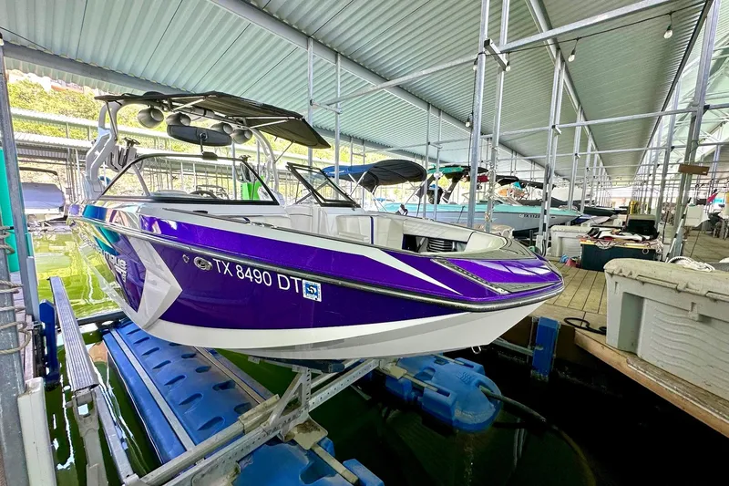 Slide: The Image of 2017 Nautique Super Air Nautique G23 boat in dock, vibrant purple and white design. - 15