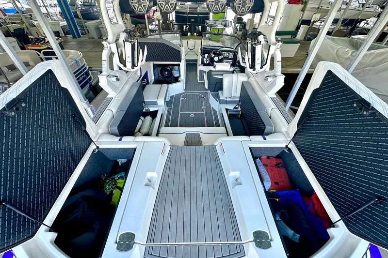 Slide: The Image of 2017 Nautique Super Air Nautique G23 interior with open storage compartments and seating. - 27