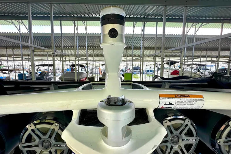 Slide: The Image of 2017 Nautique Super Air Nautique G23 boat with JL Audio speakers in a marina. - 32