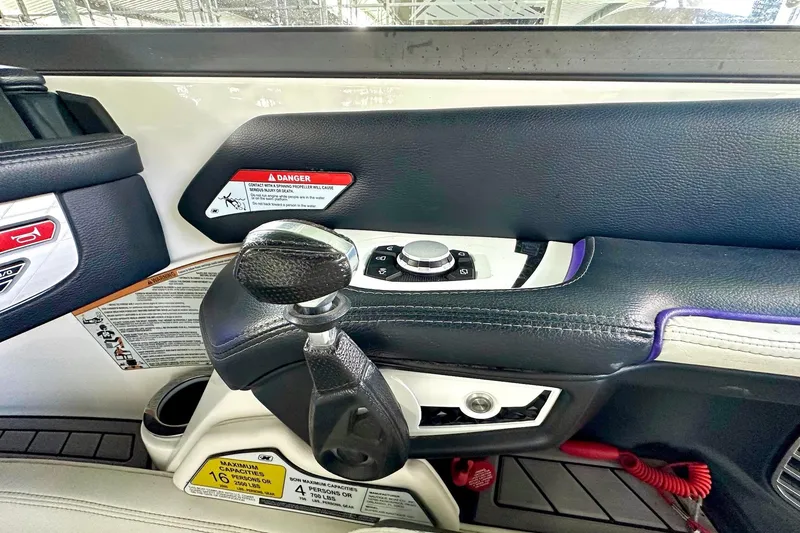 Slide: The Image of 2017 Nautique Super Air Nautique G23 control panel with throttle and warning labels. - 33