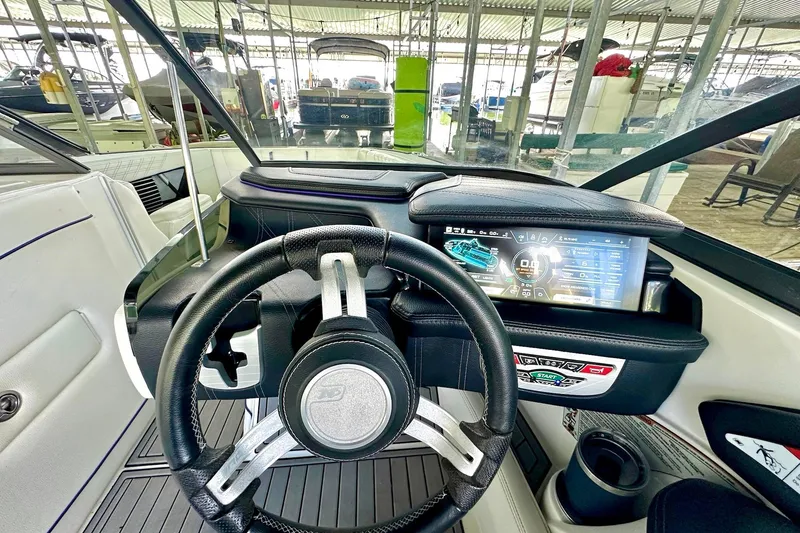 Slide: The Image of 2017 Nautique Super Air Nautique G23 dashboard with steering wheel and digital display. - 36