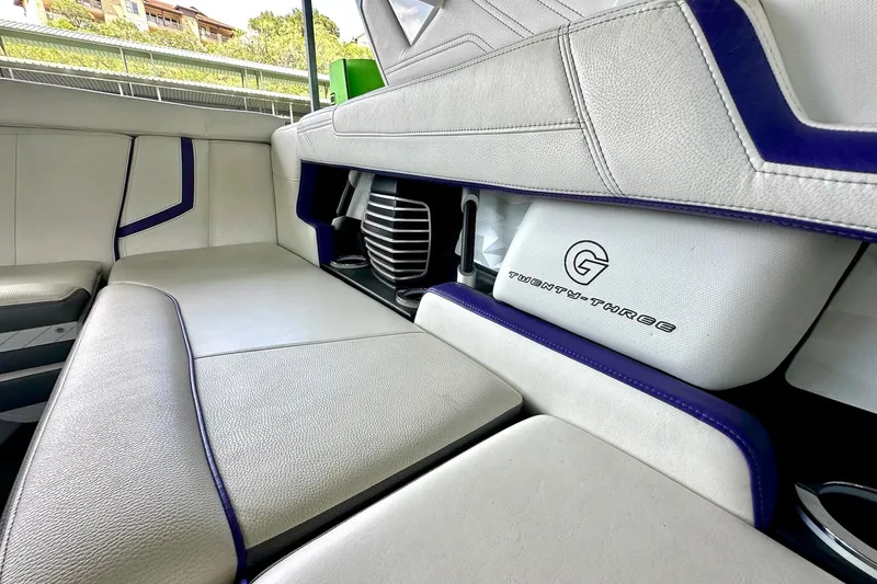 Slide: The Image of 2017 Nautique Super Air Nautique G23 interior with white and blue seating. - 37
