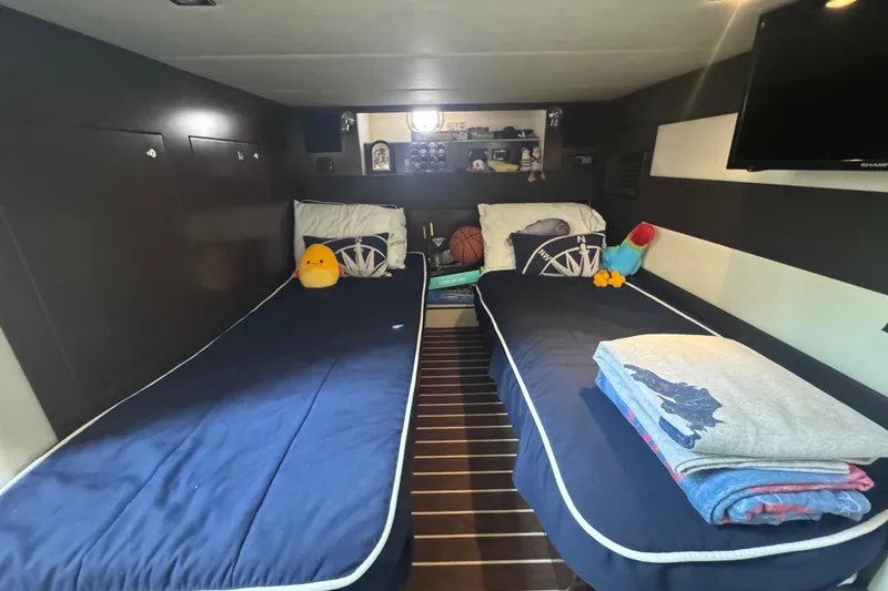 Slide: The Image of Interior of 2012 Cruisers Yachts 41 Cantius with twin beds and plush toys. - 45