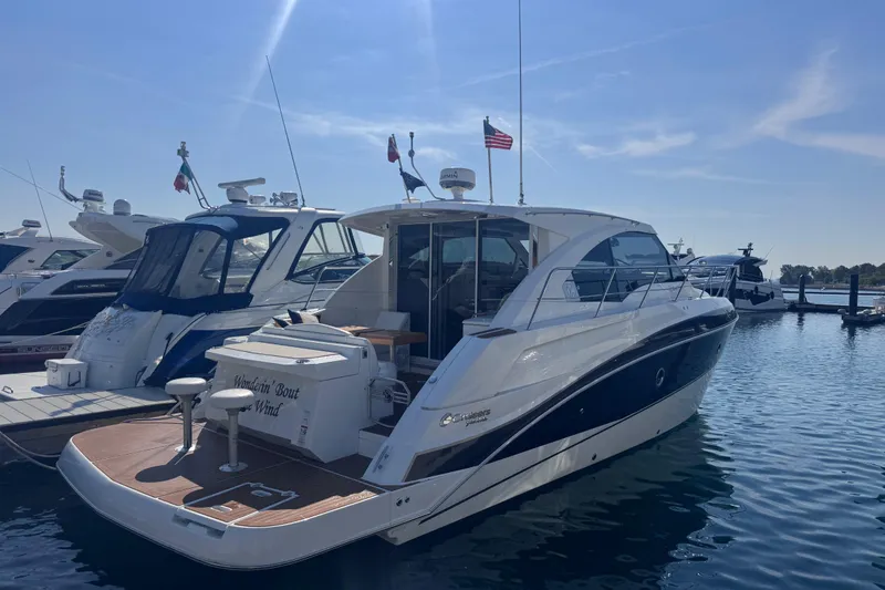Slide: The Image of 2012 Cruisers Yachts 41 Cantius docked in a marina under clear skies. - 6