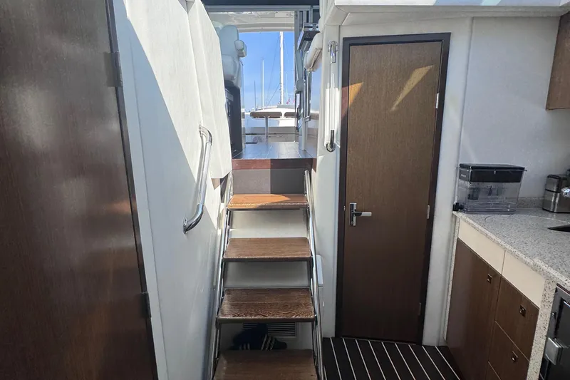 Slide: The Image of Interior view of 2012 Cruisers Yachts 41 Cantius, featuring stairs and kitchenette. - 37