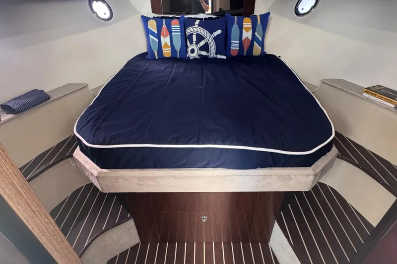 Slide: The Image of Luxurious 2012 Cruisers Yachts 41 Cantius cabin with nautical-themed bedding. - 38