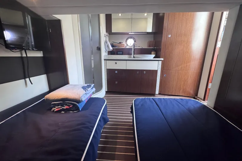 Slide: The Image of Interior of 2012 Cruisers Yachts 41 Cantius with twin beds and compact kitchenette. - 44