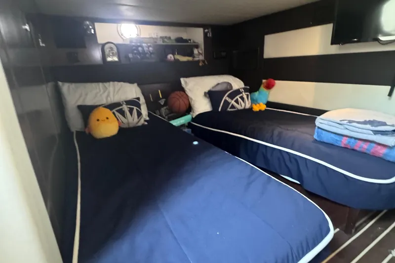 Slide: The Image of Interior cabin of 2012 Cruisers Yachts 41 Cantius with twin beds and plush toys. - 48