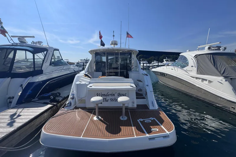 Slide: The Image of 2012 Cruisers Yachts 41 Cantius docked, featuring spacious deck and elegant design. - 5