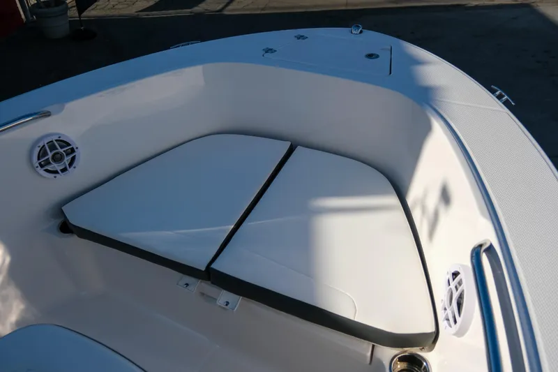 Slide: The Image of 2025 Robalo R180 Center Console boat interior with cushioned seating and speakers. - 13