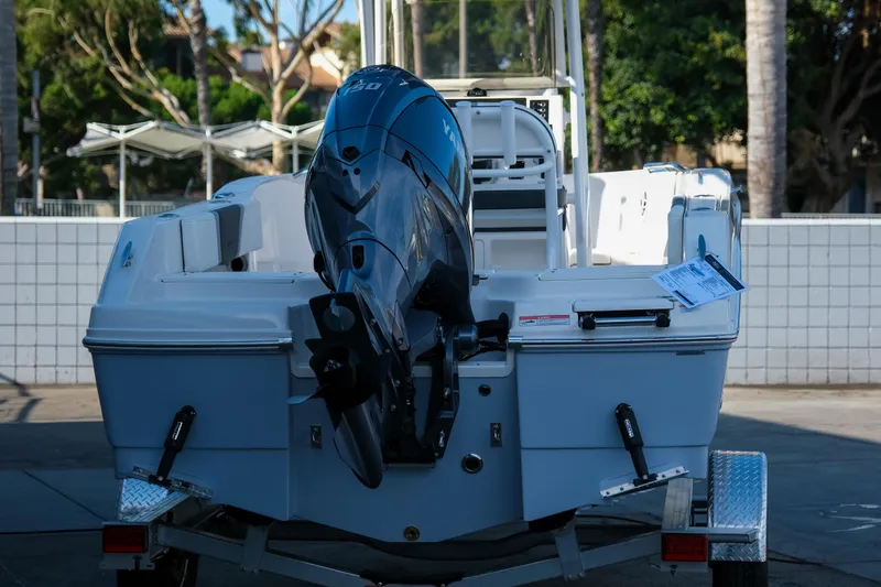 Slide: The Image of 2025 Robalo R180 Center Console boat with powerful outboard motor, parked on trailer. - 5