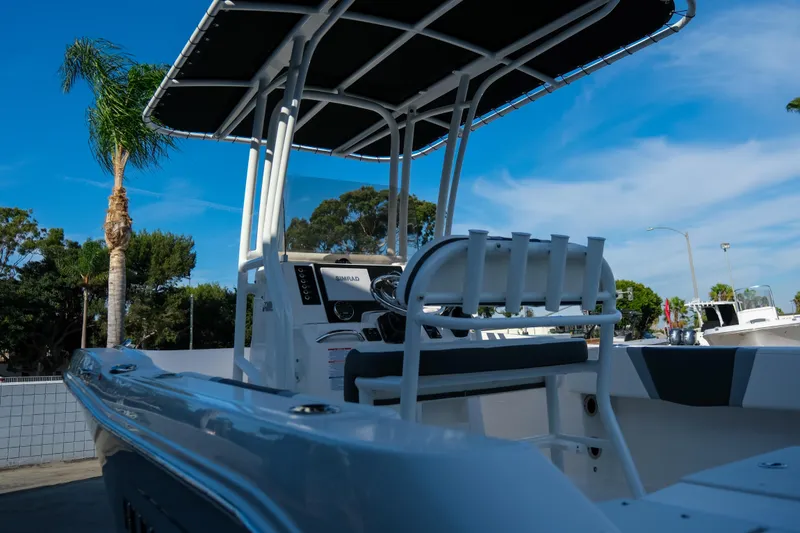 Slide: The Image of 2025 Robalo R180 Center Console boat with T-top under clear blue sky. - 6