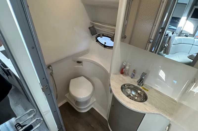 Slide: The Image of 2019 Formula 37 Performance Cruiser bathroom with toilet, sink, and mirror. - 17