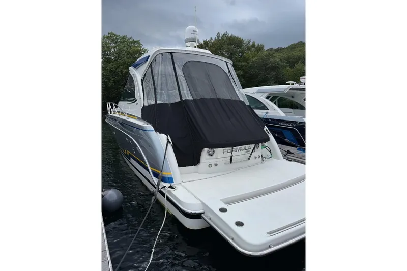 Slide: The Image of 2019 Formula 37 Performance Cruiser docked, featuring sleek design and covered cockpit. - 28