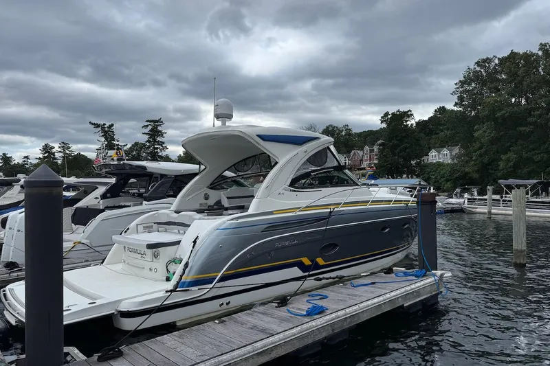 Slide: The Image of 2019 Formula 37 Performance Cruiser docked at a marina under cloudy skies. - 29