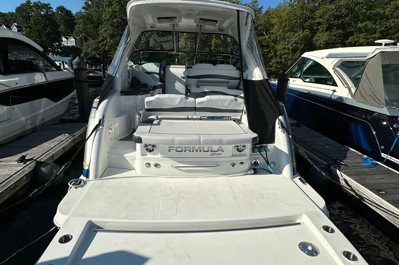 Slide: The Image of 2019 Formula 37 Performance Cruiser docked, showcasing sleek design and spacious deck. - 3
