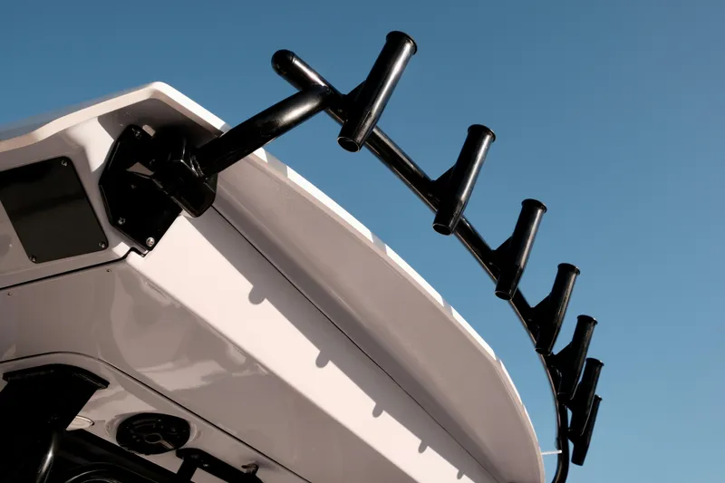 Slide: The Image of 2024 Robalo R360 Center Console boat with rod holders against clear sky. - 10